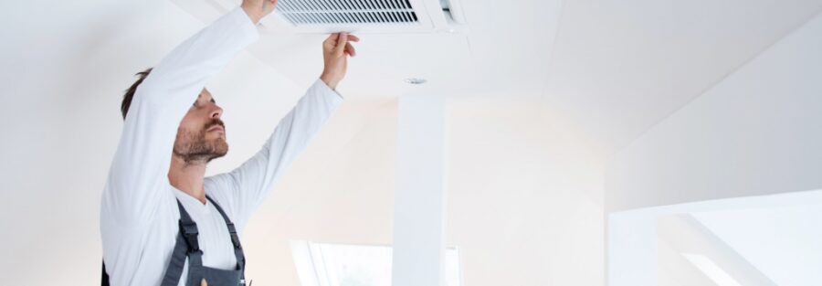 a man cleaning an air duct