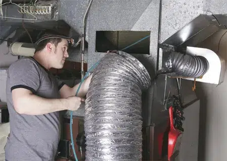 a man doing air duct cleaning