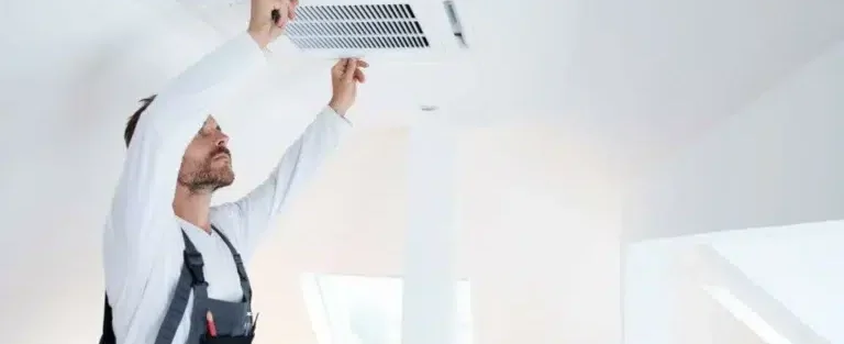A Florida man repairing an air duct