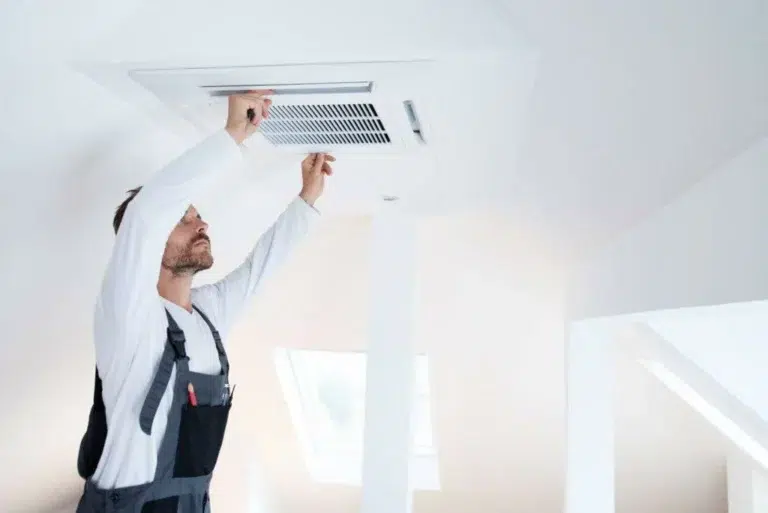 A Florida man repairing an air duct