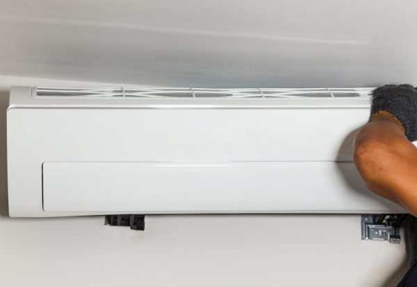 a technician installing a new air conditioning unit