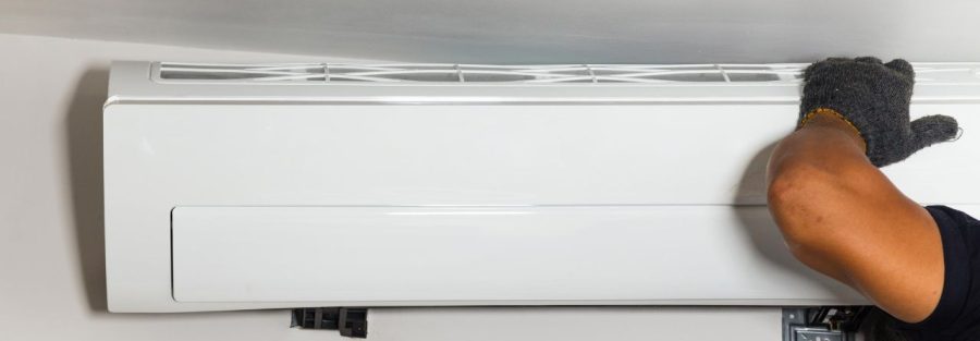 a technician installing a new air conditioning unit