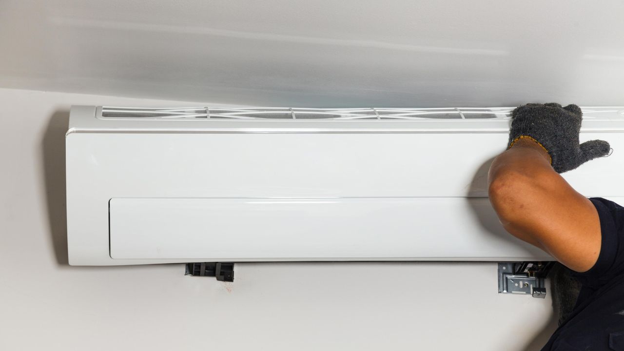 a technician installing a new air conditioning unit